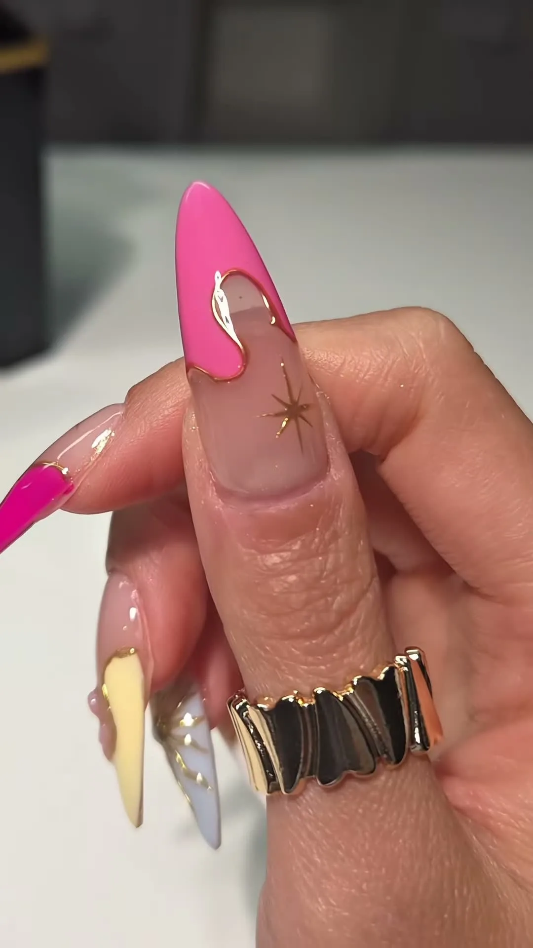 Bubblegum pink and lilac nails with gold chrome and hand drawn star accents