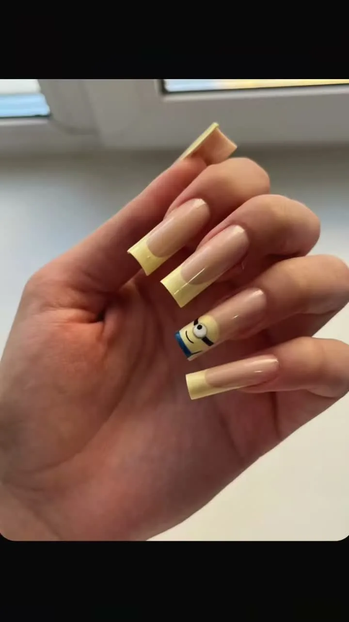 Yellow nails featuring a cartoon character design