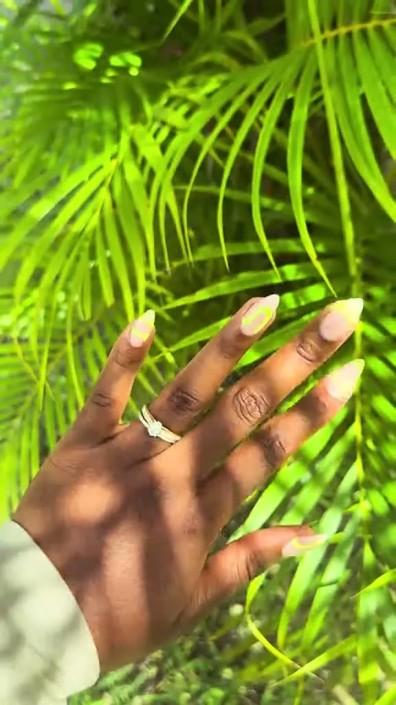 Soft buttery yellow summer nails on an almond shape
